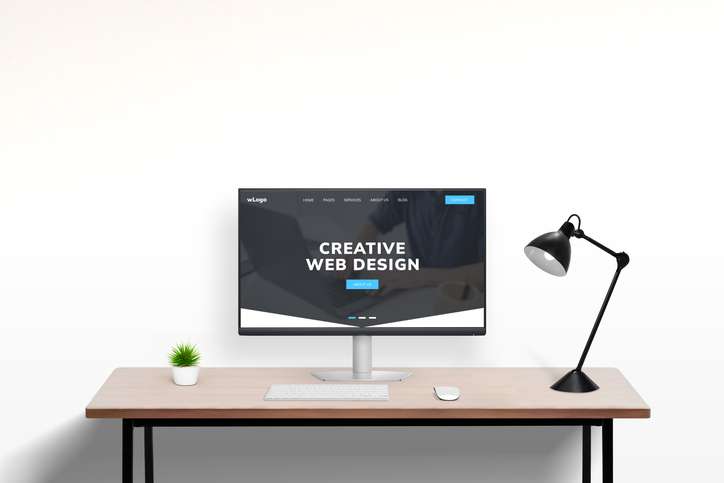 Web design studio portfolio page concept displayed on modern computer in office work desk setting. Showcase of creative digital projects and professional design work