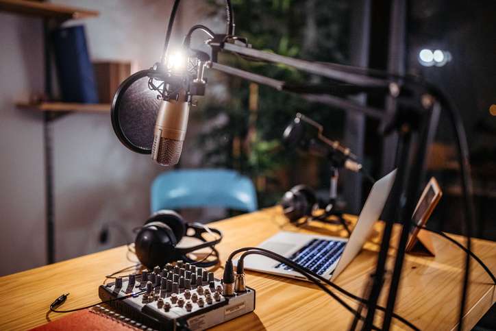 Podcast studio picture of a podcast studio with microphones, sound mixer and laptop