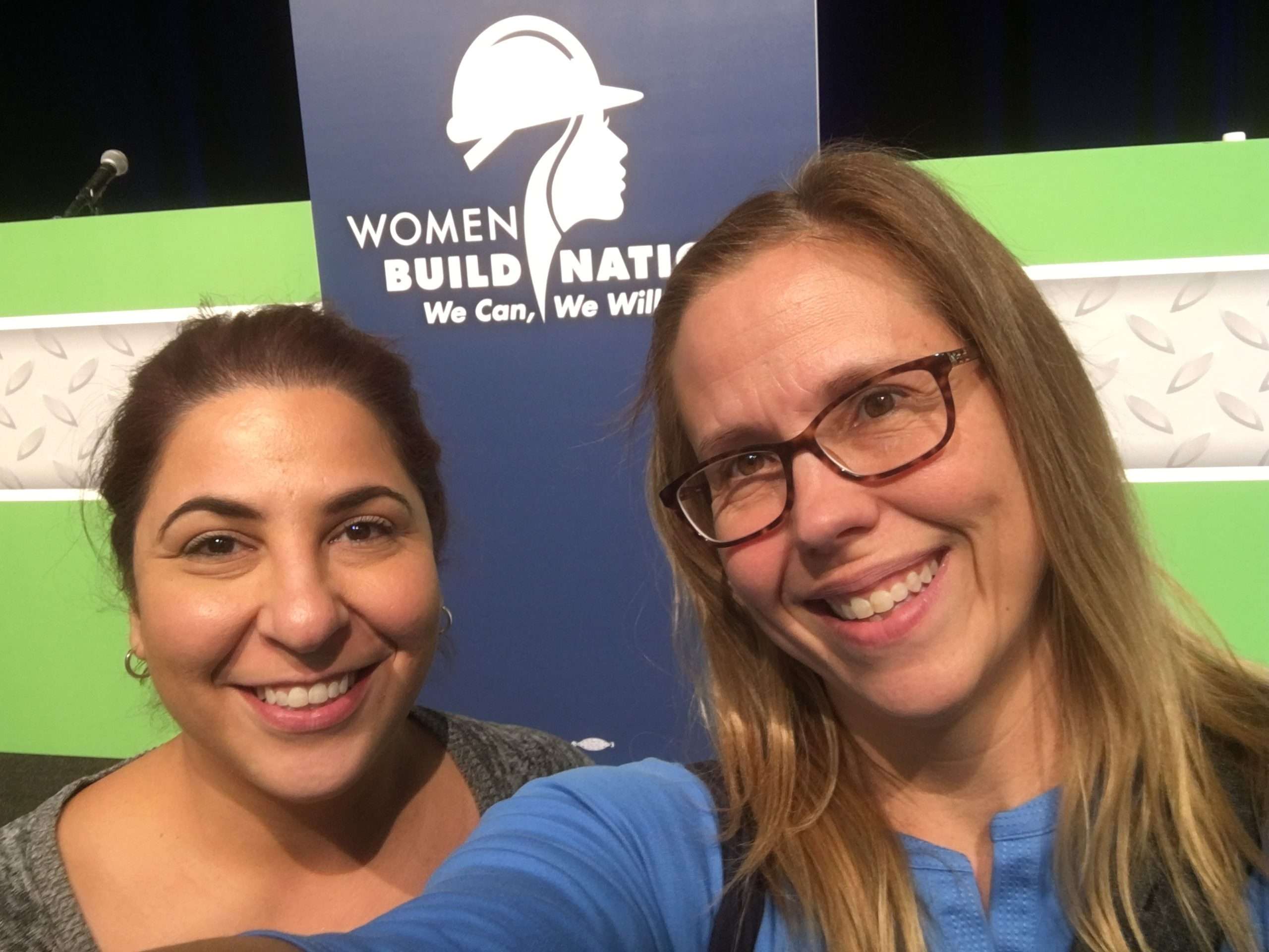 A selfie of two women at an industry event.