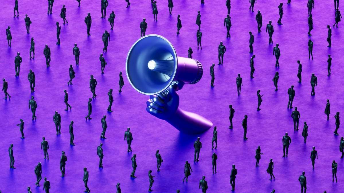 A large megaphone held by a hand rises above a crowd of small human figures on a purple surface, viewed from above.
